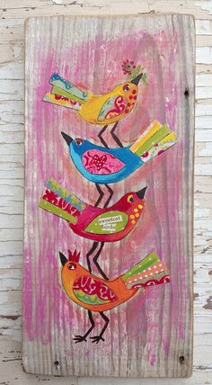 a wooden plaque with birds painted on it