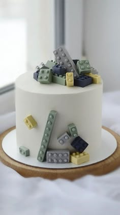 a white cake with lego blocks on top