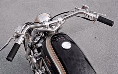 the front end of a black and silver motorcycle