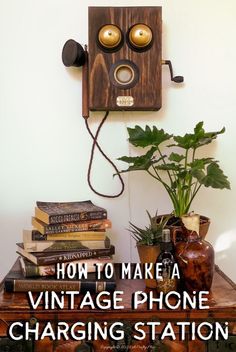 an old fashioned phone sitting on top of a table next to a potted plant