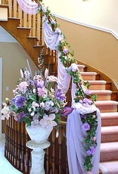 a staircase decorated with flowers and ribbons