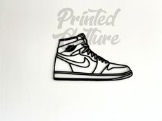 Eco-Friendly Nike Inspired Jordan 1 High Wall Art Elevate your sneaker obsession to new heights with this stunning, eco-friendly tribute to the iconic Nike Jordan 1 High silhouette! 3D printed from sustainable, plant-based PLA, this statement piece isn't just for your feet - it's a conversation starter for your walls or desk. Showcase your love for sneakers and the planet with this unique work of art. Take your sneaker obsession to the next level! Order your eco-friendly Nike Air Max 1 silhouette today! As these are 3D printed to order, please allow 2-3 weeks for processing before shipment. As this is a 3D printed product, there may be some minor imperfections such as smudges, layer lines and stitching. These do not affect the functionality of the product. For best results, dust with a mic High Wall Art, Nike Jordan 1 High, Sneakerhead Gifts, Nike Inspired, Nike Jordan 1, Printed Wall Art, Gaming Room, Jordan 1 High, Birthday Gift For Him