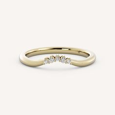 a yellow gold ring with three diamonds