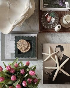 a table topped with pictures and flowers on top of it