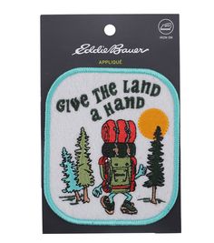 an embroidered patch with the words give the land a hand and a backpack on it