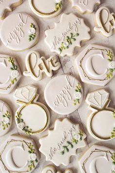 decorated cookies are arranged on a table with white and green trimmings that read, we love you