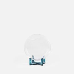 a clear and blue object sitting on top of a white surface with no one around it