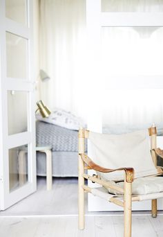 a chair sitting in the middle of a room with white walls and wood flooring