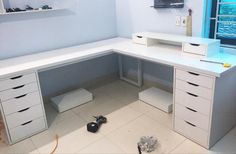 a white desk with drawers and shelves in a room