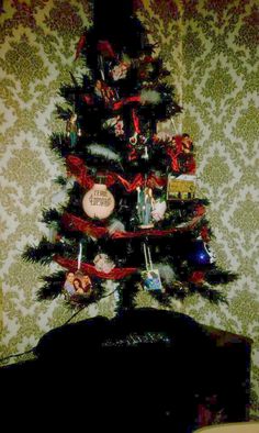 a decorated christmas tree in the corner of a room