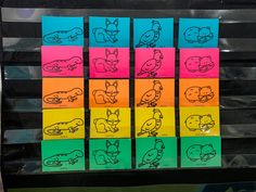 several different colored stickers with cartoon animals on them in front of a store window