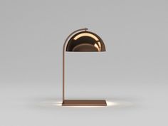 a table lamp that is on top of a metal stand with a white light coming from it