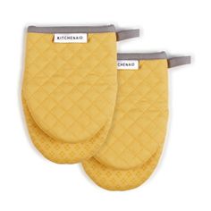 two yellow oven mitts with the words mitchell on them, one in grey and one in