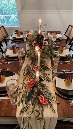 the table is set with fruit and candles for dinner guests to enjoy in their own home