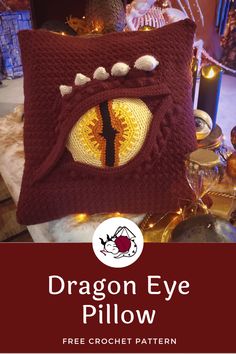 a crocheted pillow with the words dragon eye pillow on it and an image of a