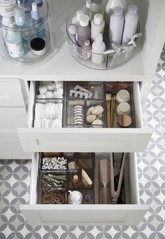 an organized drawer in a bathroom with toiletries and other items on the drawers,