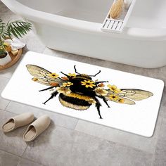 a yellow and black bee on a white bath mat next to a tub in a bathroom