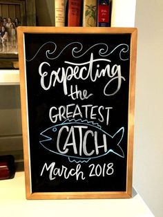 a chalkboard sign that says expecting the greatest catch march 2018