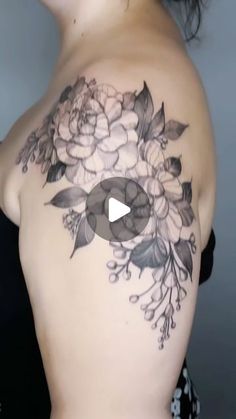 a woman's shoulder with flowers on it