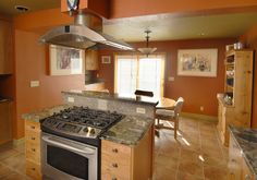 a kitchen with an oven, stove and dining room table