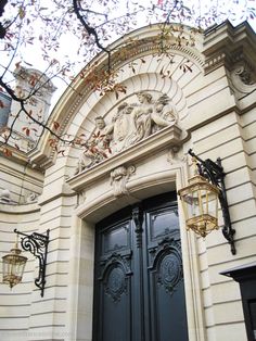 an ornate building with two black doors