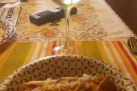 a table topped with a bowl of food and a plate of pizza on top of it