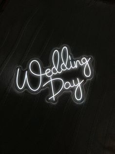 a neon sign that says wedding day on it's back pocket, with the word wedding pay written in white