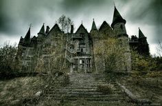 an old abandoned castle with stairs leading up to the top and bottom floors on a cloudy day