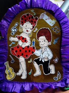 a purple paper plate with two children on it