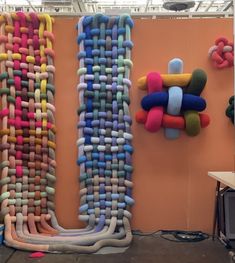 an art installation made out of knits and yarnsticks on display in a room