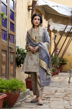 The set consists of straight cut handwork printed kurta with gota detailing, 3/4th sleeves, round neck, knee length teamed with printed trouser and a dupatta with border. Suit Fabric-Georgette Dupatta Fabric-Organza Kurta length - 40 in Pants length - 38 in Model is wearing size small. She is 5.8” tall. Washing Care-Dry Clean Eid Straight Kurta Set With Gota Work, Eid Gota Work Straight Kurta Set, Unstitched Straight Kurta Palazzo Set With Gota Work, Eid Palazzo Set With Sheer Dupatta In Cambric, Cambric Palazzo Set With Sheer Dupatta For Eid, Mulmul Palazzo Set With Sheer Dupatta, Mulmul Palazzo Set With Sheer Dupatta And Straight Kurta, Straight Kurta Palazzo Set With Sheer Dupatta In Mulmul, Straight Kurta With Printed Motifs For Transitional Season