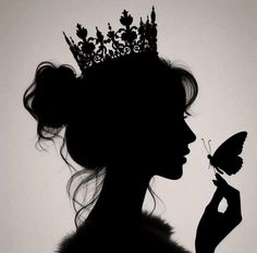 the silhouette of a woman with a butterfly in her hand and a crown on her head