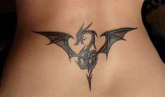 a woman with a dragon tattoo on her lower back and the upper part of her stomach