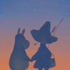 two rabbits standing next to each other in the sunset