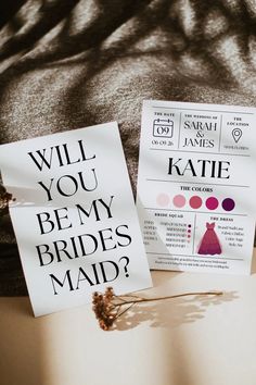 two paper signs that say will you be my brides maid and will you be my groom?