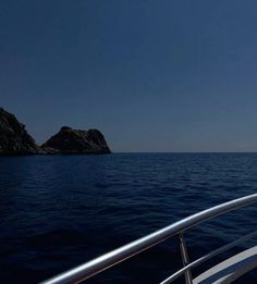 there is a rock in the middle of the water and it looks like an island