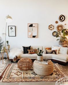 a living room filled with lots of furniture and decor on top of a white rug