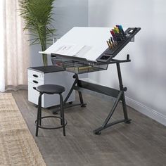 an office desk with two stools next to it and a potted plant in the corner