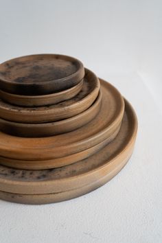 a stack of wooden plates sitting on top of each other