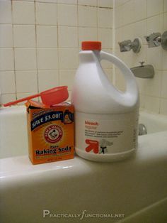 a bottle of baking soda sitting on top of a bathtub next to a soap dispenser