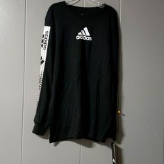 Size Med 10/12 Sporty Black T-shirt For Fall, Adidas Long Sleeve Top With Logo Print, Black Long Sleeve Top With Logo, Adidas Long Sleeve Sports T-shirt, Adidas Tops With Graphic Print For Fall, Adidas Long Sleeve T-shirt For Spring, Adidas Long Sleeve Cotton T-shirt, Adidas Cotton Long Sleeve Top, Adidas Long Sleeve Cotton Top