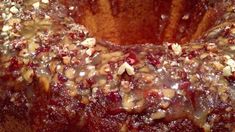 a bundt cake with nuts and cranberry sauce