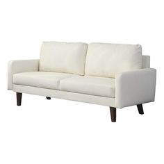 a white couch sitting on top of a wooden floor