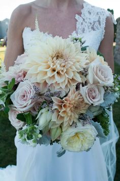 a bride holding a bouquet of flowers in her hands