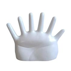 a white plastic hand that is on top of a table