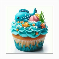 a cupcake with blue frosting and sea creatures on top