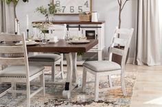 a dining room table with chairs and a clock on the wall