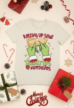 Rolling up some Tamalitos Navidenos, Feliz navidad shirt, Spanish Christmas, Grinch shirt, Funny Spanish, Regalos en español, Latina shirt This classic unisex jersey short sleeve tee fits like a well-loved favorite. Soft cotton and quality print make users fall in love with it over and over again. These t-shirts have-ribbed knit collars to bolster shaping. The shoulders are tapered for a better fit over time. Dual side seams hold the garment's shape for longer.  .: 100% Airlume combed and ringsp Posada Shirt, Christmas Merch, Grinch Shirt, Funny Spanish, Spanish Christmas, Grinch Shirts, Christmas Grinch, Spanish Humor, Raleigh Nc