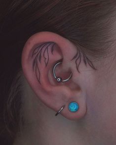 an ear with two piercings attached to it