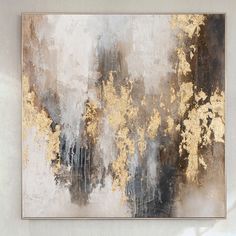 an abstract painting with gold and grey colors on the wall in front of a white background